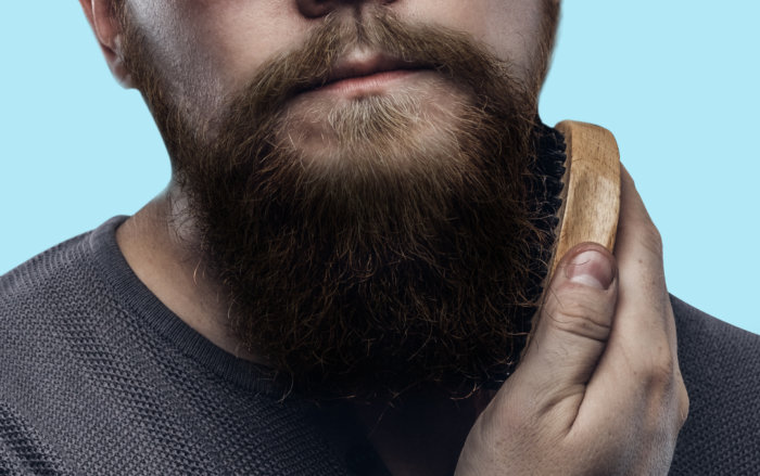 Pat dry your beard. Using a beard brush, brush your beard in the direction of hair growth to detangle and tame the hair. 